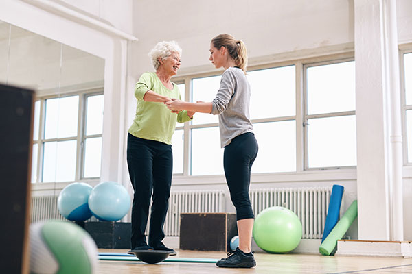 physio working with woman on balance physio working with woman on balance