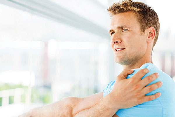 Man holding a sore shoulder