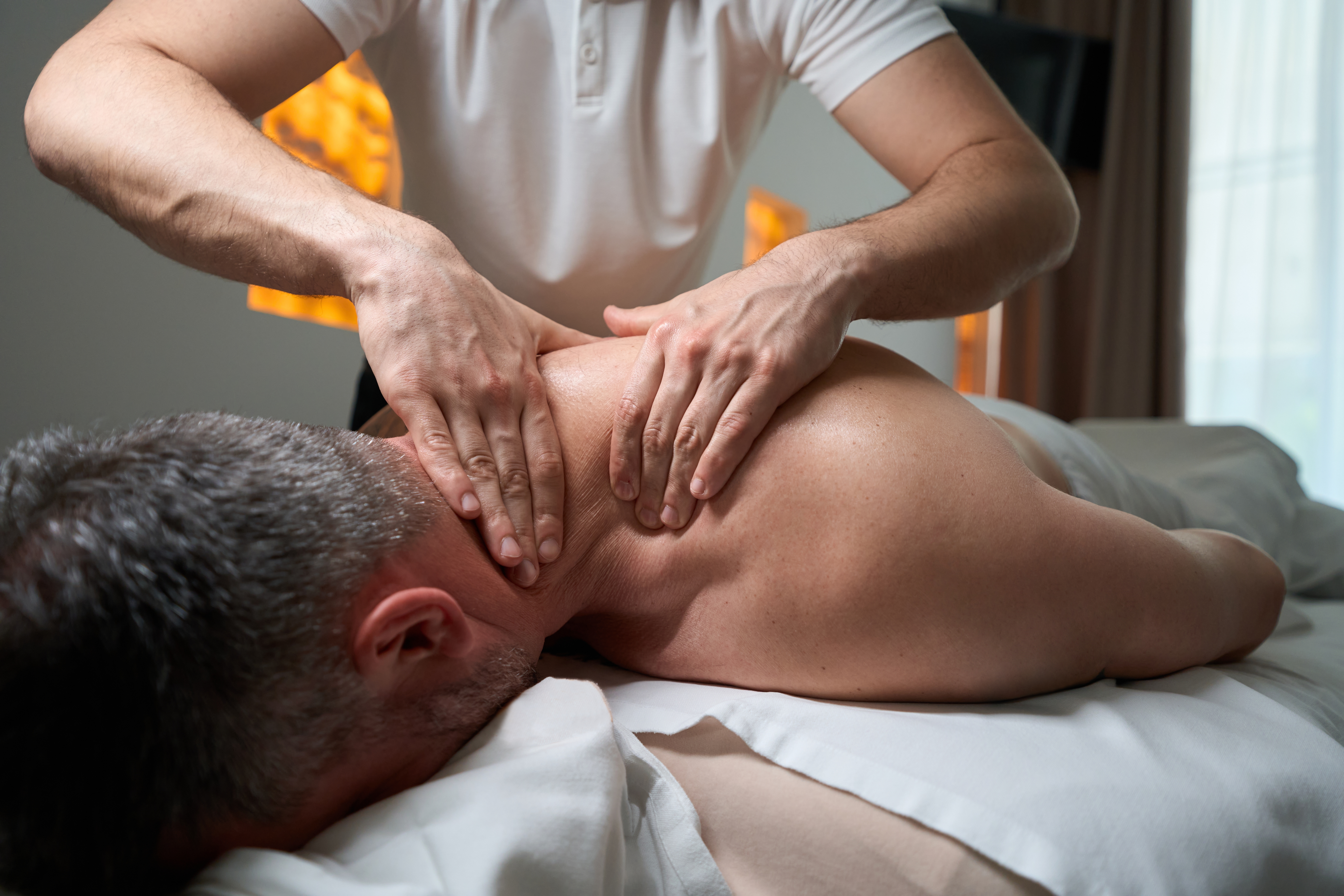 Man receiving upper back massage